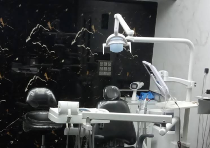  Interior of a dentist's office with a dental chair and equipment.
